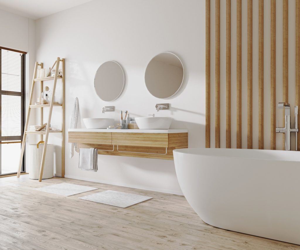 Stylish bathroom interior with modern tub, wooden ladder with bath accessories and beautiful decor